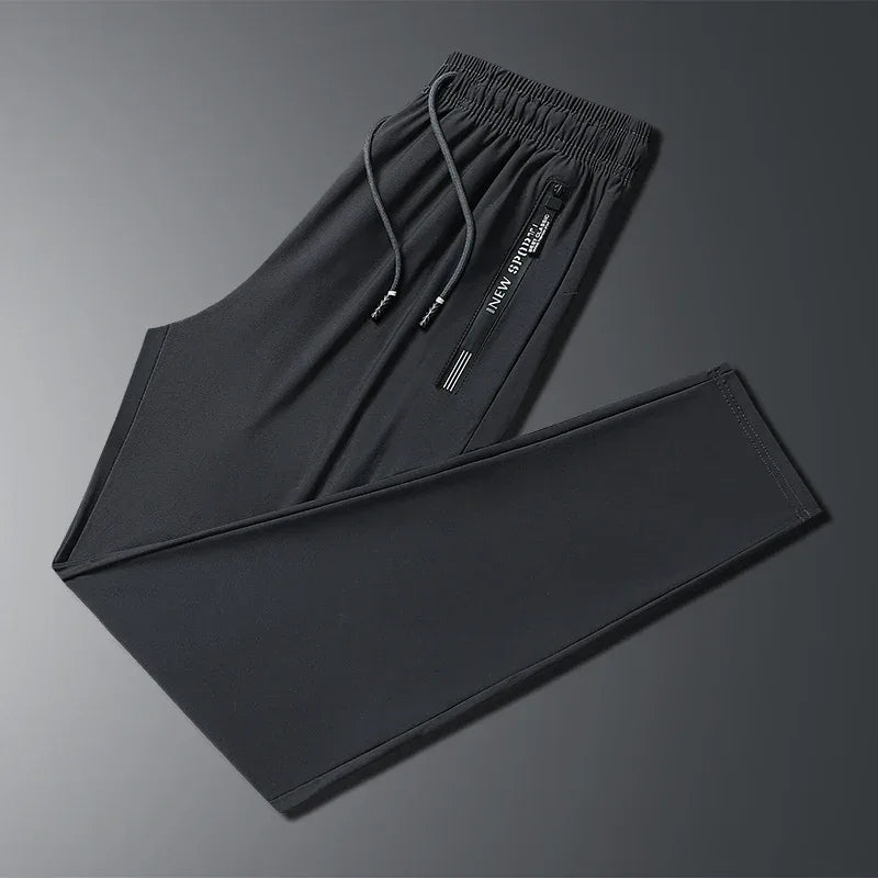 New Summer Korean Ice Silk Elastic Trousers Cool Thin Casual Men'S Loose Long Large Size Small Foot Sports Pants 8XL We Men's Store